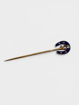 a close up of a gold and blue broochle broochle on a white background