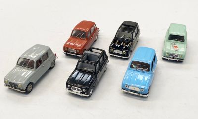 plusieurs petites voitures sont alignées sur une surface blanche