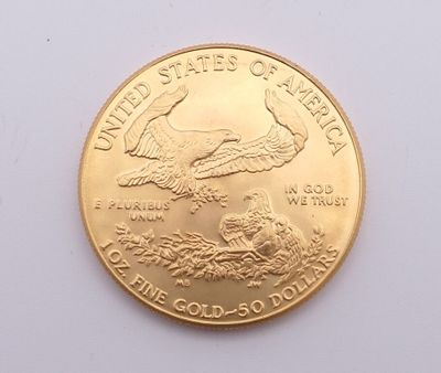La pièce est en or et représente un aigle.