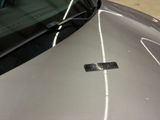 a sticker on the hood of a silver car