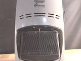 an image of a white electric heater on a wooden table