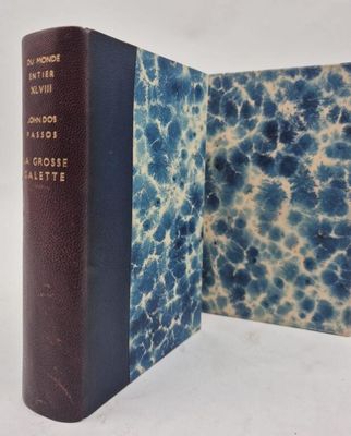 an old book opened to show a blue and white cover