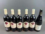 six bottles of red wine lined up in a row