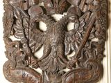 an image of a wood carving of a bird with a crown on it ' s head
