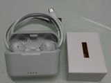 a white box with a charger and headphones on it