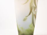 a glass vase with a green and white design on it