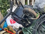 a pile of garbage outside of a fenced in yard