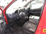 the interior of a small red car with the door open
