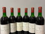 six bottles of wine are lined up in a row on a table