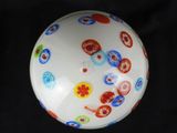 a white bowl with red, blue, and green designs on it