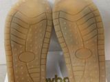 the soles of a pair of shoes are on a white box