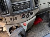a car dashboard with a remote control and other items in it