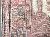 an image of a rug on the floor with a cat sleeping on it