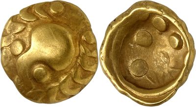 a close up of two gold buttons on a white surface