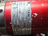 a close up of a red fire extinguisor on a table