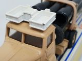 a toy truck that has a bunch of containers on top of it