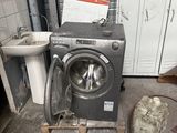 a washer and a sink in a dirty room