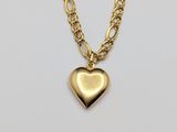 a gold heart pendant on a chain with a chain link
