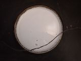 a white plate with a wire on it on a table