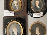 three framed portraits of men and women are displayed on a wall