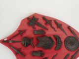 a red plaque with a lot of different items on it