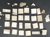 several pieces of white marble are arranged on a black surface
