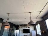 three lights hanging from the ceiling in a room