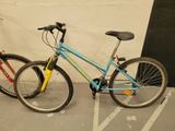 two bikes parked next to each other in a parking lot