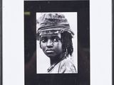 framed photograph of a woman with a hat on her head