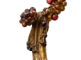 an image of a statue of a woman holding a bunch of grapes