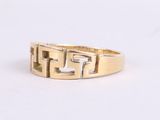 a close up of a gold ring on a white surface