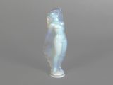 a glass figurine of a woman on a gray background