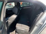 the back seat of a car with the door open in a parking lot