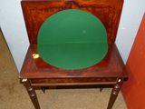 a small wooden chair with a green seat on it