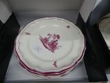a stack of plates in a box with a picture on them