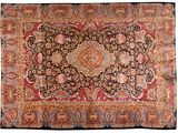 an antique persian rug with a medallion design on a black ground