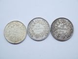 three different types of coins on a white surface