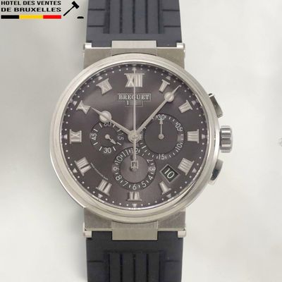 a black watch with roman numerals on the face