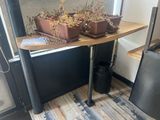 a small table with two pots of plants on it