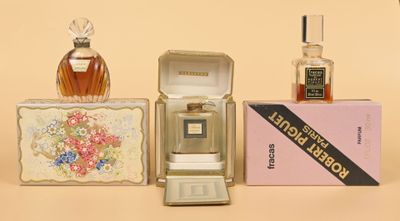 a small box with a perfume bottle and a small box with a perfume in it