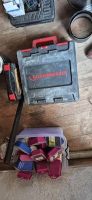 a box of tools on the floor next to a pair of scissors and a pair of scissors