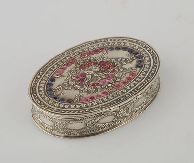 an ornate silver box with a pink and blue design on it