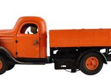 un camion orange garé sur une surface blanche