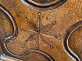 a close up of a wooden cabinet with carvings on it