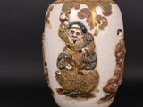 a white vase with a picture of a man on it