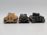 three toy tanks sitting side by side on a white surface