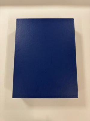 a blue book sitting on top of a white table