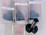 four plastic containers with screws in them on a white surface