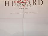 the poster for the movie le husband is shown on the wall