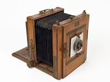 an old camera that is sitting on a white surface